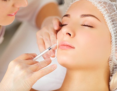 Woman getting BOTOX® near lips