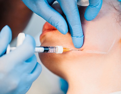 Woman getting BOTOX® in her jaw