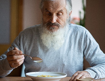 Man eating a bowl of soup