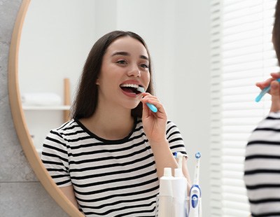 Young woman brushing her teeth